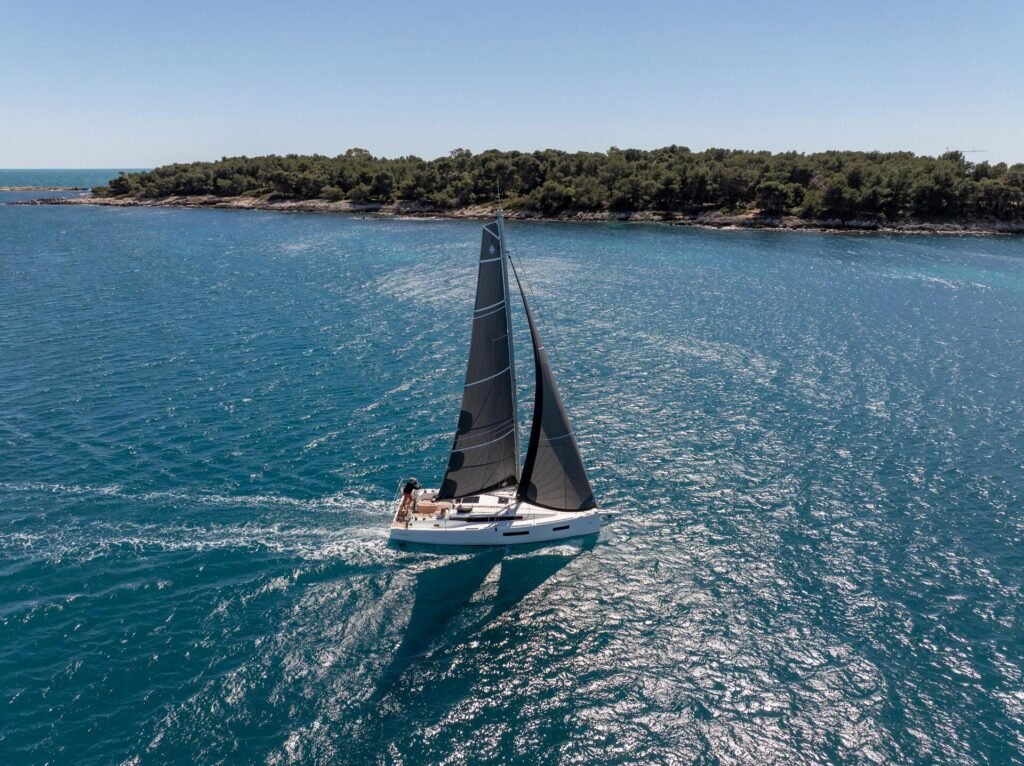 French monohull for sixteen guests, classic profile at anchor