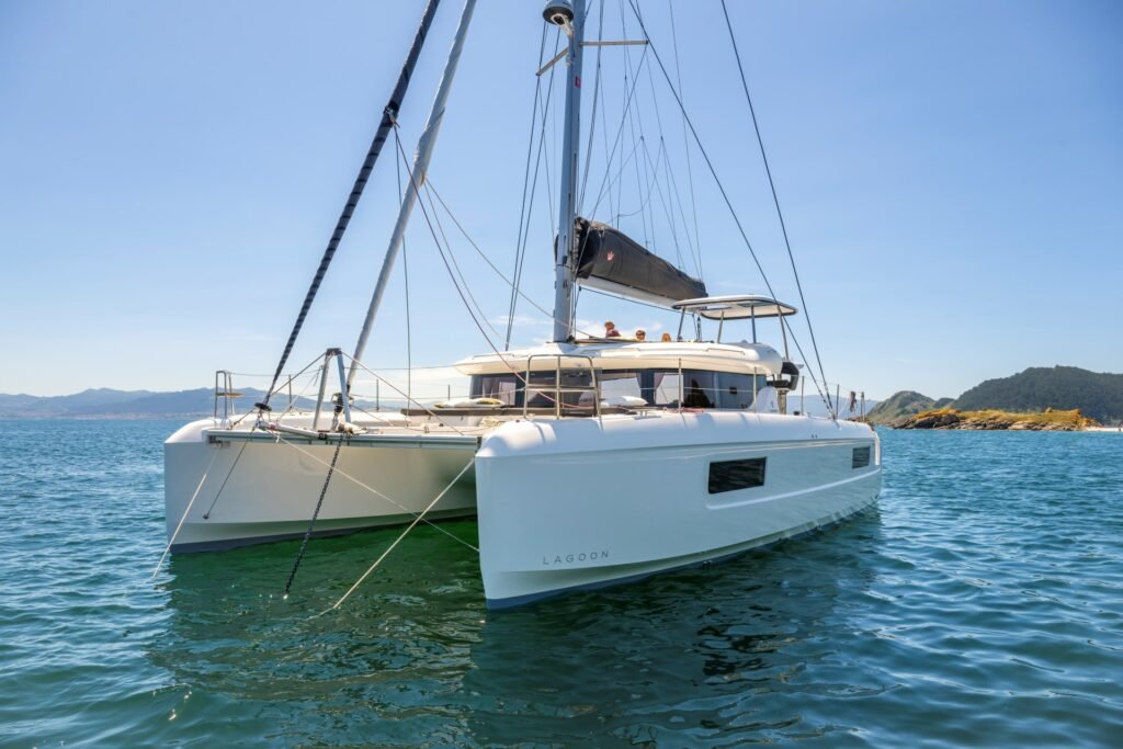 luxury catamaran yacht at anchor showing spacious deck layout