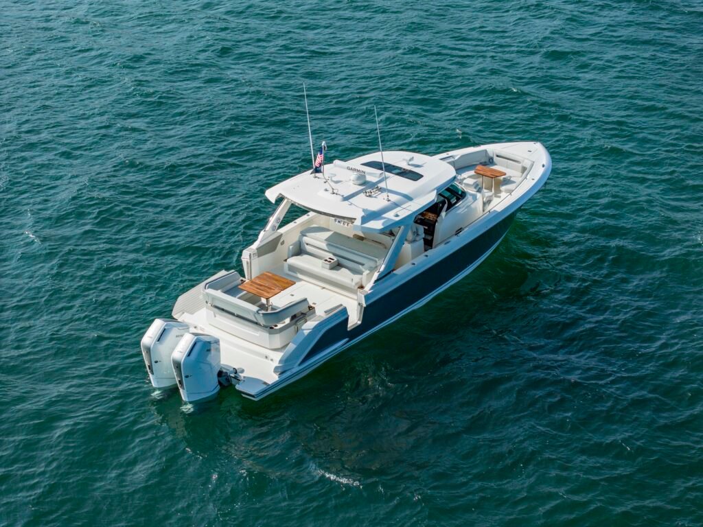 Outboard powered planning hull yacht at anchor