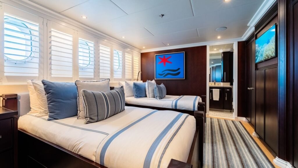 Twin-bed guest stateroom with a red artwork