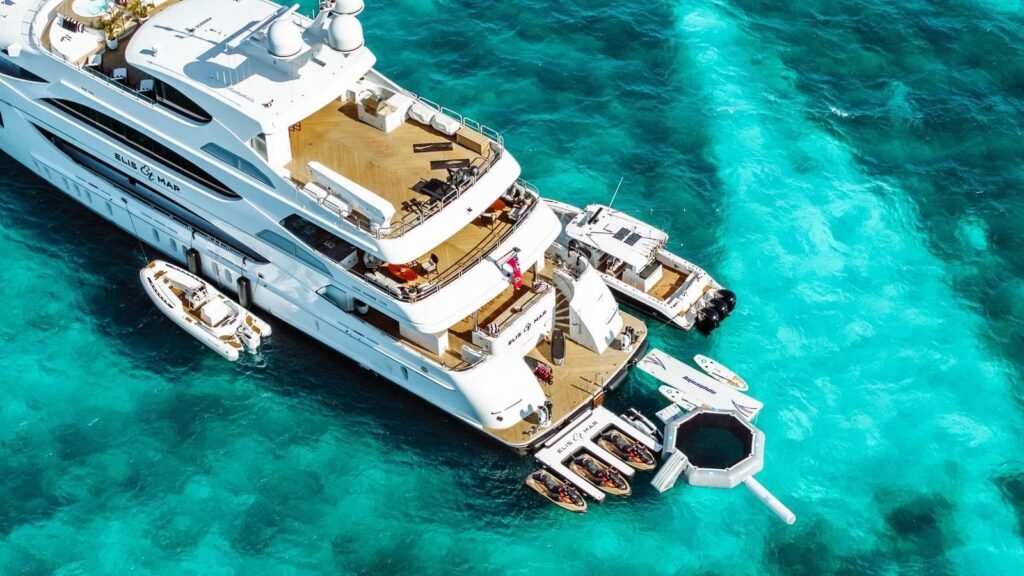 Aerial view of the yacht at anchor with a tender