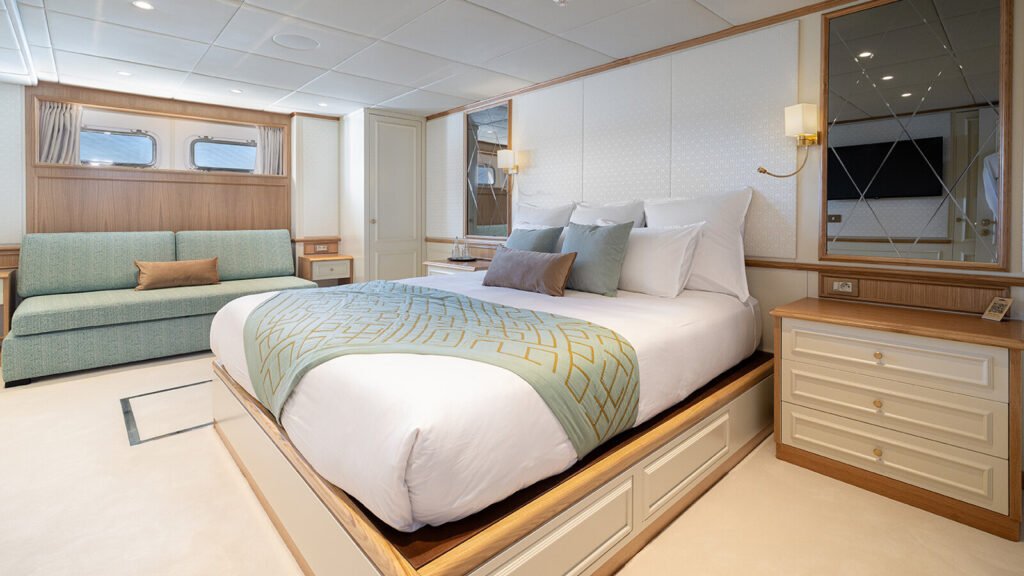 Stateroom with a sage green sofa