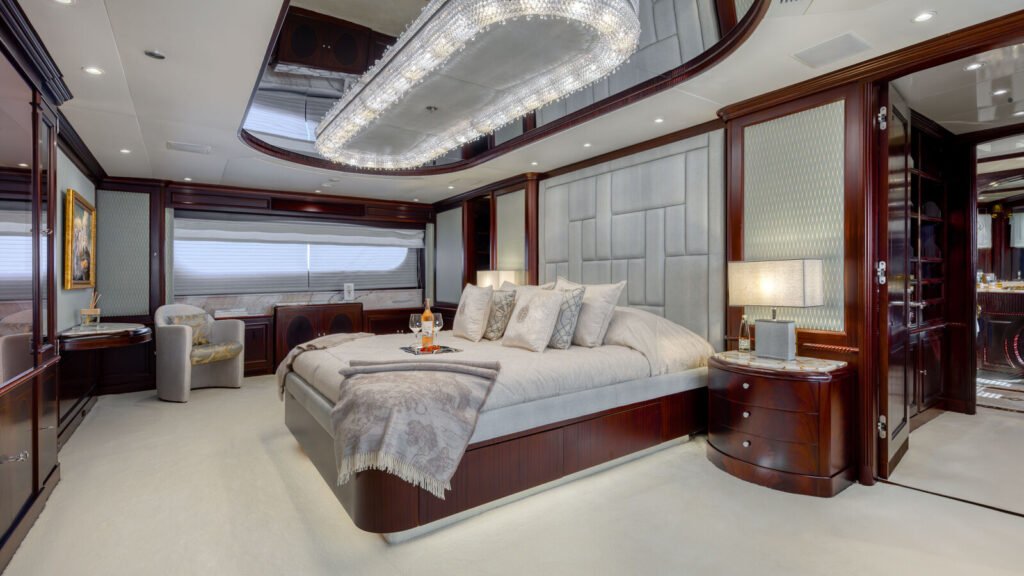 Master suite with a mahogany-framed bed and oval mirrored ceiling detail
