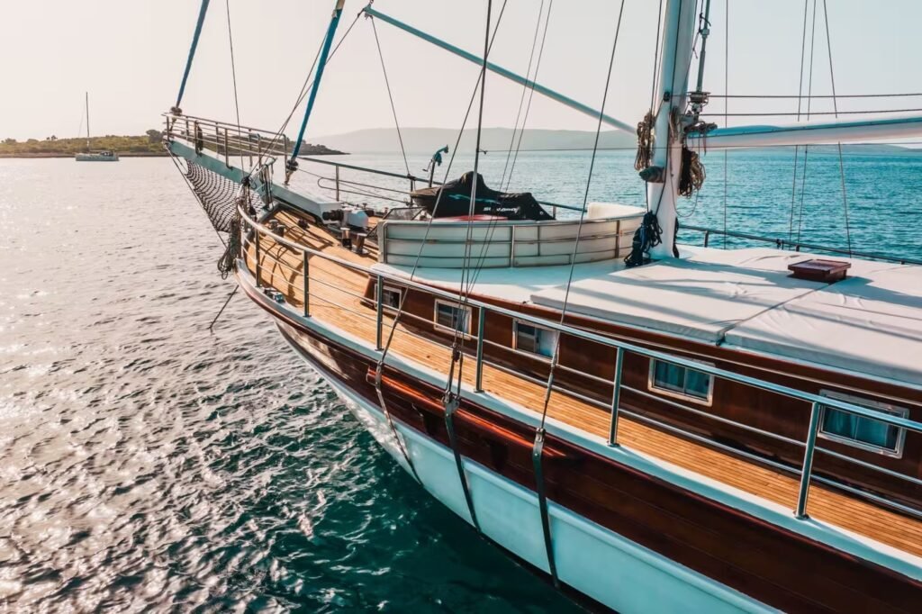 Sailing yacht for charter with Jet Skis, aerial view under sail