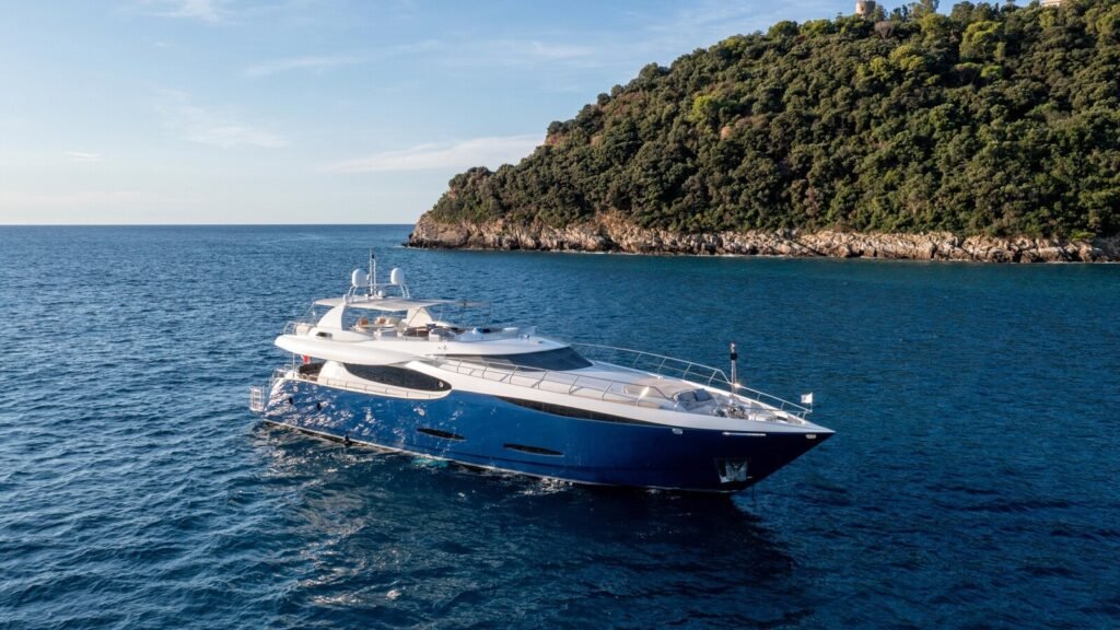 Amalfi Coast motor yacht charter, exterior profile at anchor off the cliffs