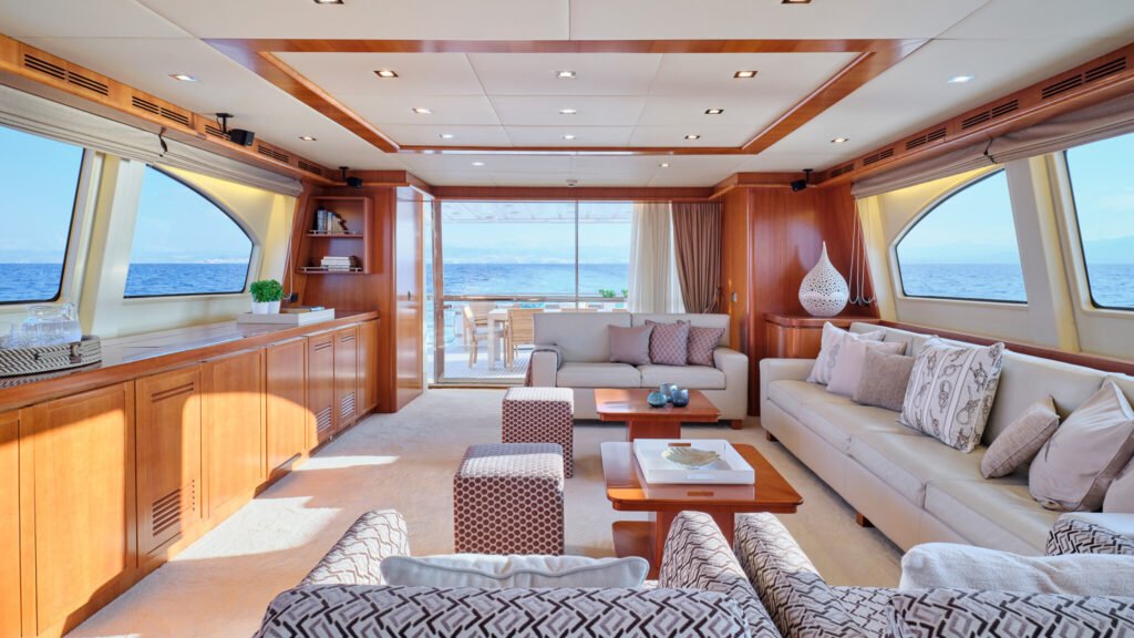 Main salon lounge with cream sofas and sea view windows