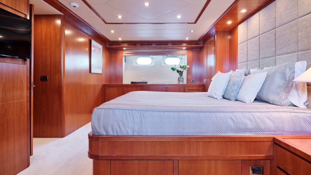 Master stateroom with king bed and twin portholes