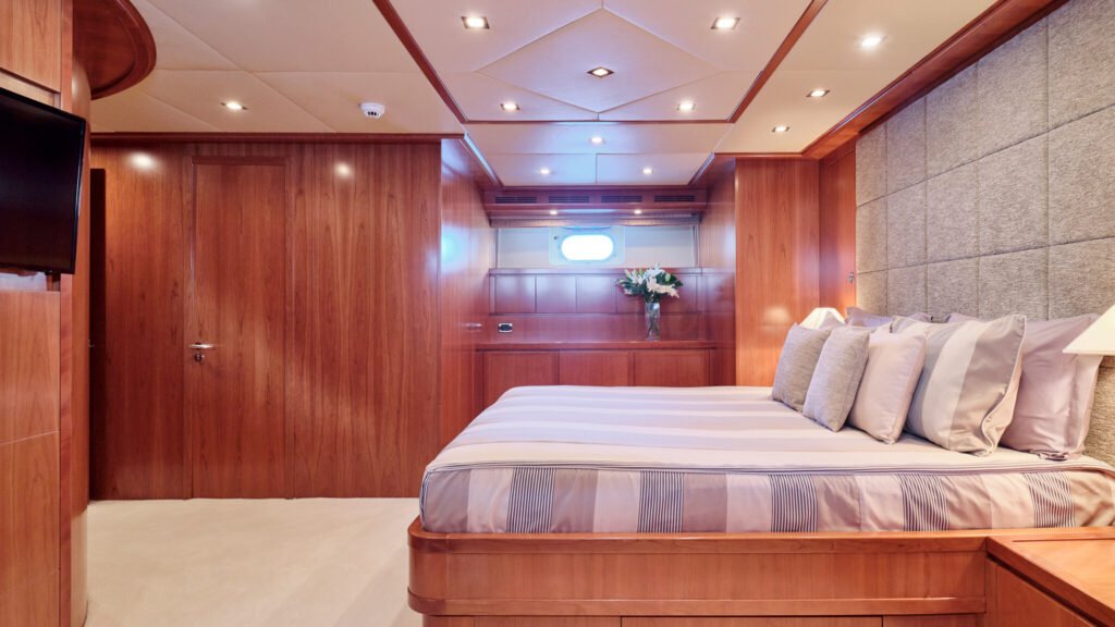 Guest stateroom with grey upholstered headboard