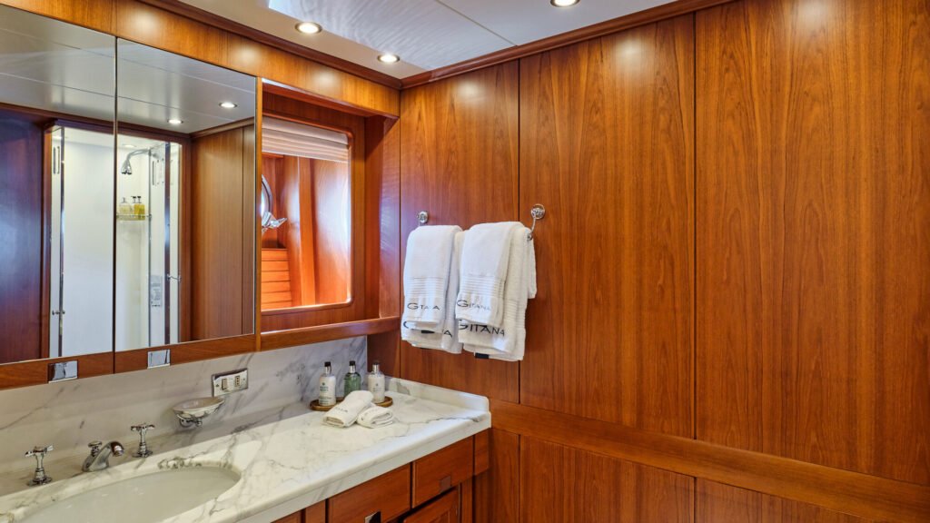 Master bathroom with marble vanity and GITANA-branded towels