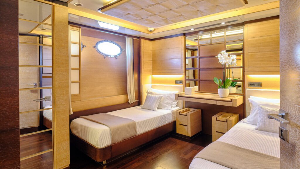 Twin guest cabin with vanity and porthole