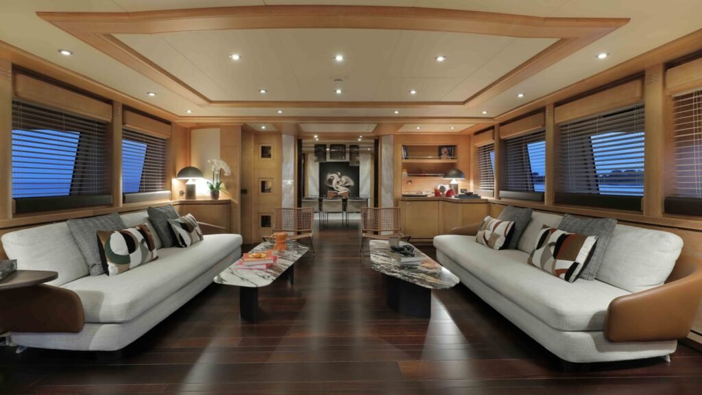 Main salon with grey sofas and dark wood flooring
