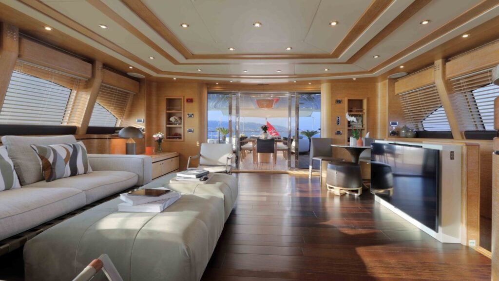 Salon toward aft deck, open-plan view with flag on tender