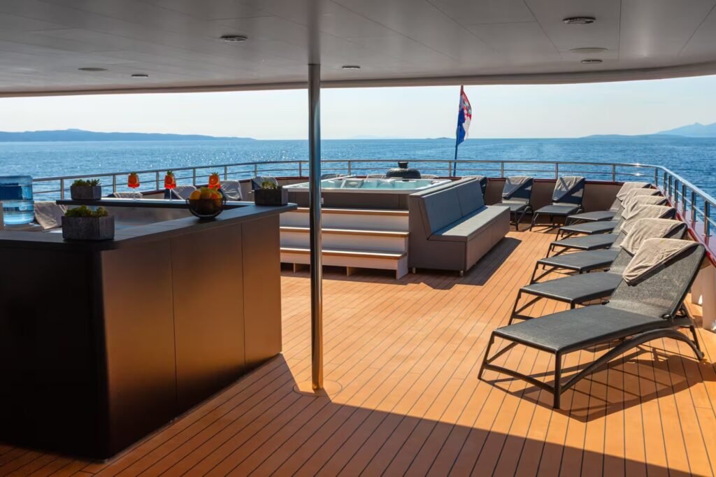 Charter yacht with spa and e-foil, exterior profile at anchor