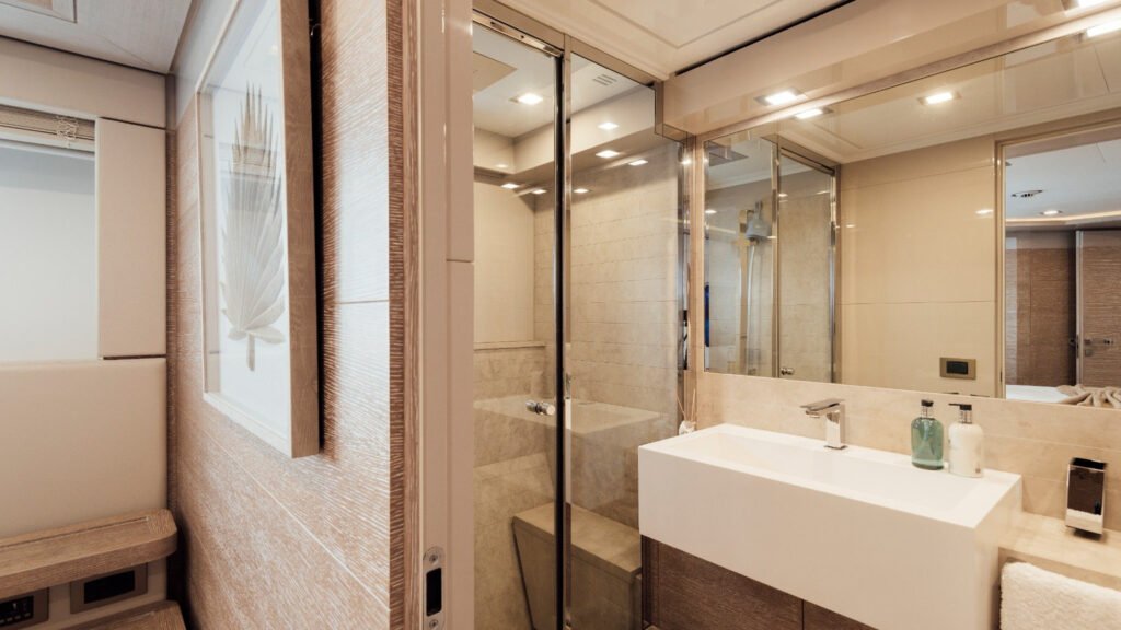 En-suite bathroom with glass shower and twin basins aboard motor yacht Centurion