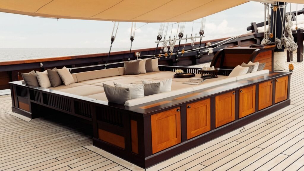 Thailand Phinisi charter yacht, carved bow against limestone karst scenery