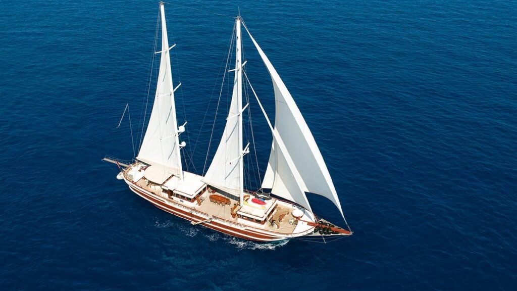 Classic ketch at anchor off Ibiza, cockpit and varnished deck detail