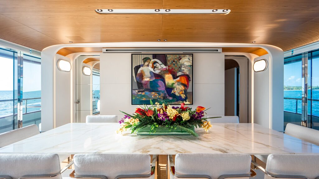 Formal dining room aboard KOJU with marble table and artwork