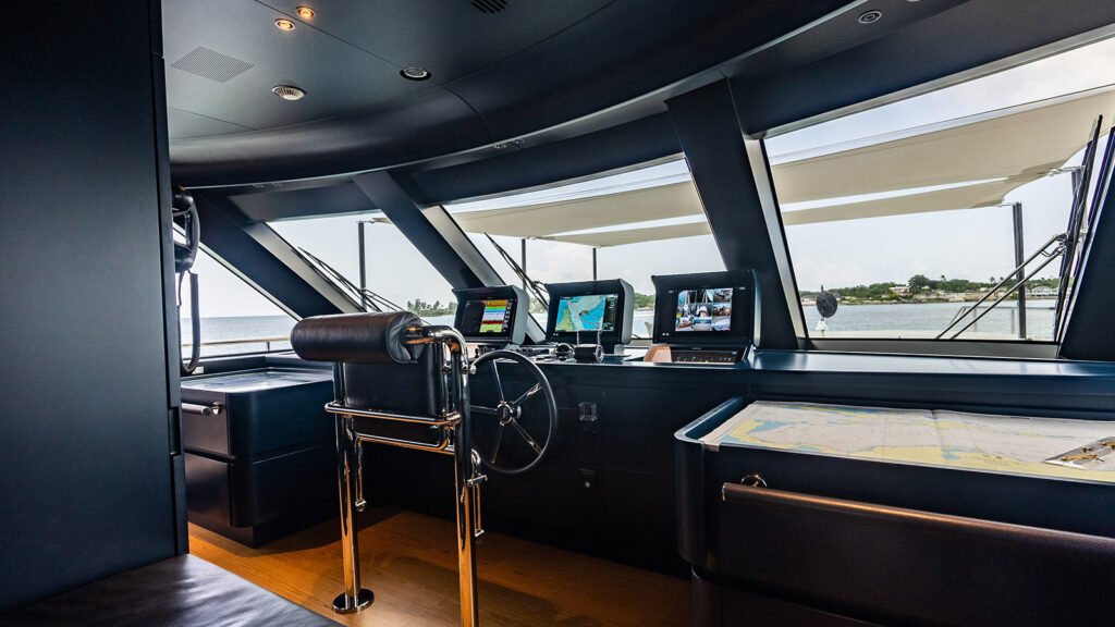 Wheelhouse aboard KOJU with ship's wheel and navigation displays