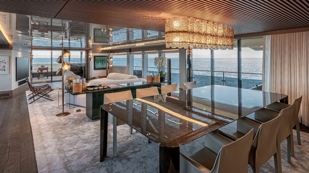 Formal dining room aboard ONE ZERO under a crystal chandelier