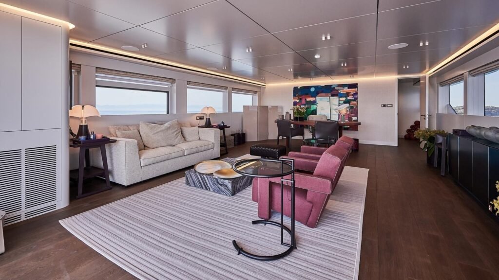 Skylounge aboard ONE ZERO with deep red armchairs