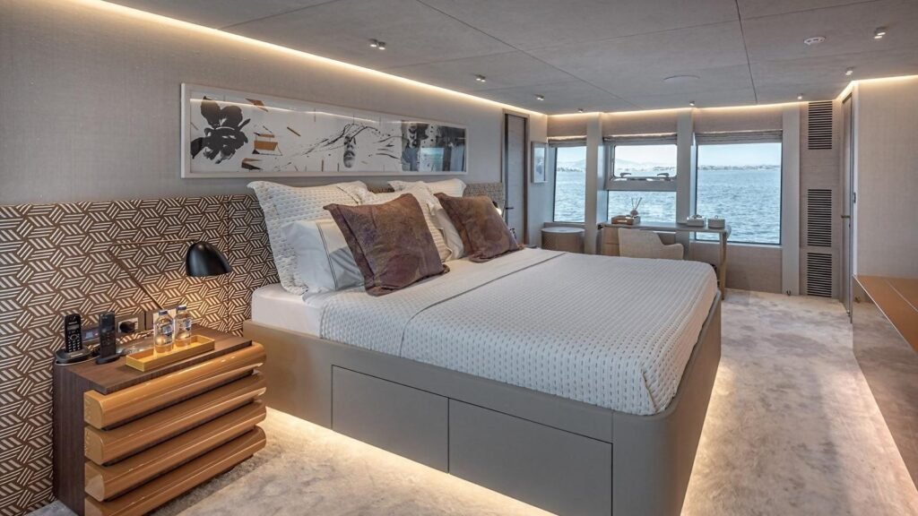 Full-beam master suite aboard ONE ZERO with patterned headboard wall