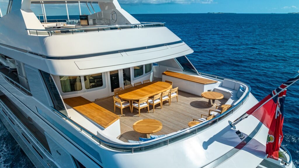 Motor yacht charter in Ibiza, exterior profile at anchor in a Balearic cove