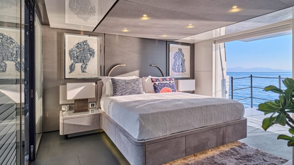 Full-beam master suite aboard RIANA II with a fold-down private balcony open to the sea