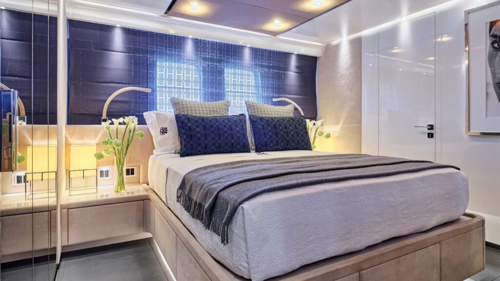 Guest suite aboard RIANA II with quilted indigo headboard