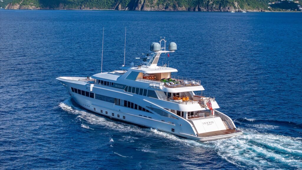 Motor yacht charter off Formentera, exterior profile in turquoise water