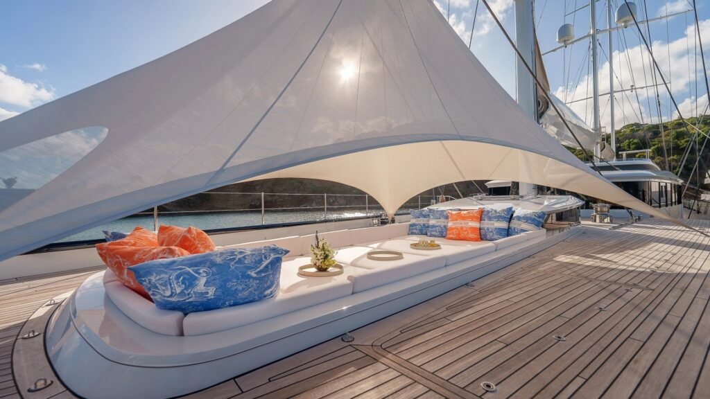 Crewed sailing yacht Stromboli, bow at anchor in volcanic bay