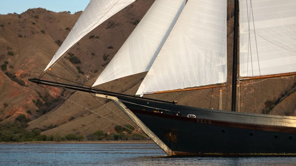 Vietnam charter sailing yacht, deck view across Bai Tu Long Bay at dusk