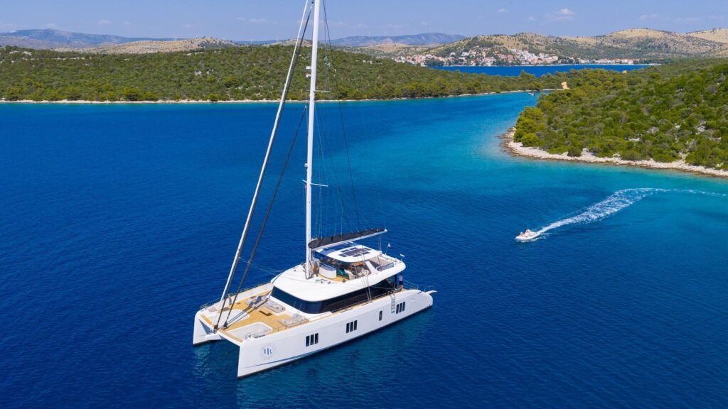 HONEYBIRD Sunreef catamaran at anchor aerial